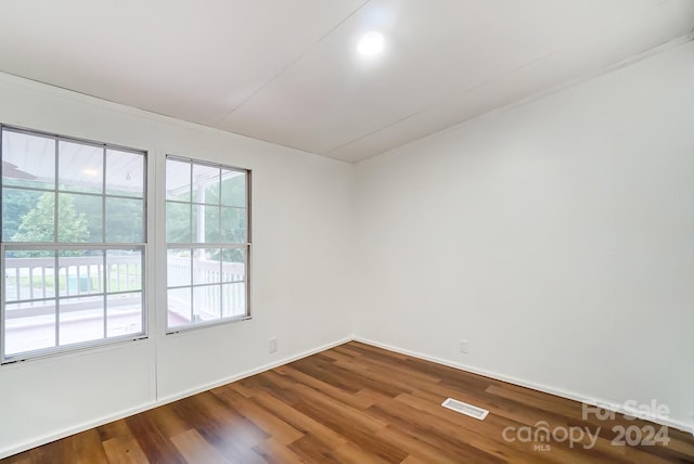 unfurnished room with hardwood / wood-style floors