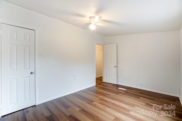 spare room featuring ceiling fan and hardwood / wood-style flooring