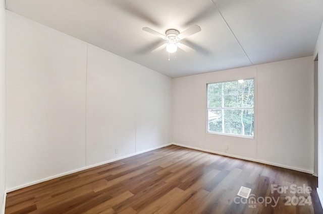 empty room featuring dark hardwood / wood-style flooring and ceiling fan