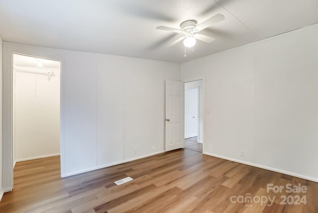 spare room featuring light hardwood / wood-style flooring and ceiling fan