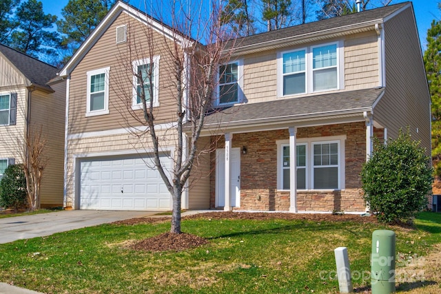 view of front of home featuring a garage and a front yard