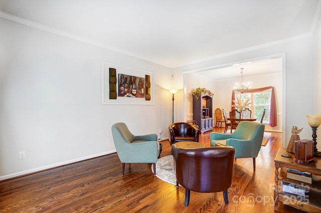 sitting room featuring a notable chandelier, ornamental molding, and hardwood / wood-style flooring