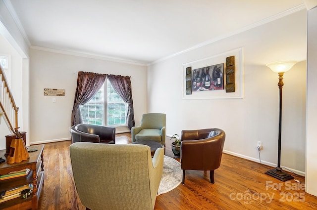 living area featuring ornamental molding and hardwood / wood-style flooring