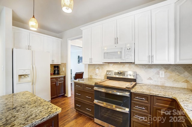 kitchen featuring white cabinetry, white appliances, hanging light fixtures, and dark hardwood / wood-style flooring