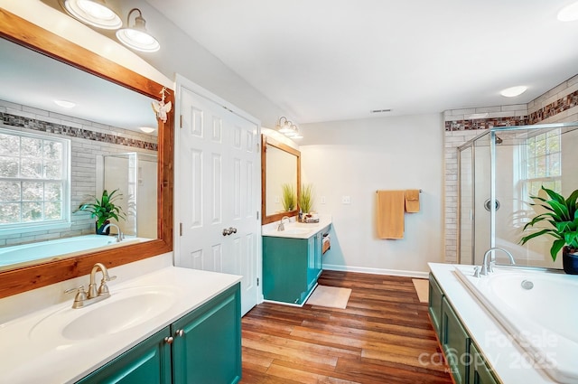 bathroom with separate shower and tub, vanity, a wealth of natural light, and hardwood / wood-style floors