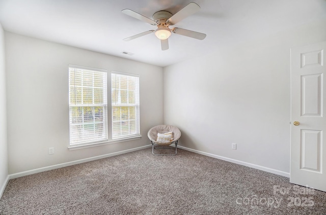 spare room featuring carpet and ceiling fan