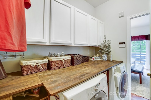 clothes washing area with washing machine and dryer and cabinets