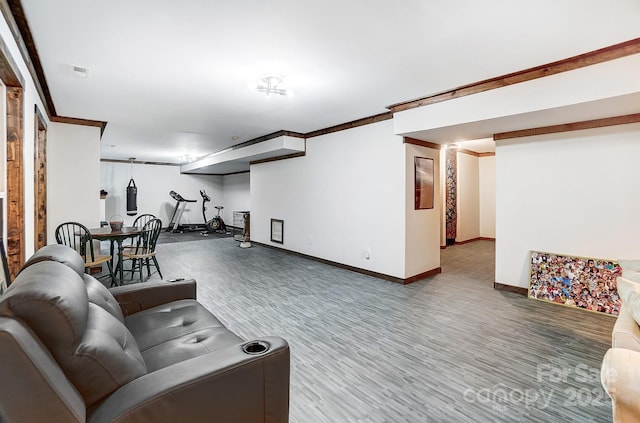 living room with hardwood / wood-style flooring and crown molding