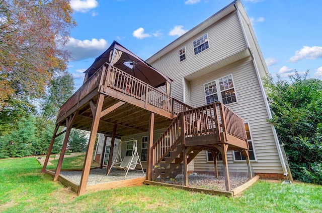 rear view of house featuring a yard and a wooden deck