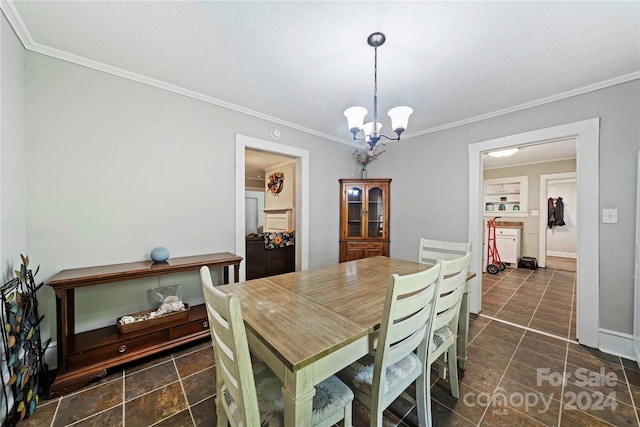 dining area featuring crown molding and an inviting chandelier