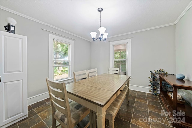 dining space featuring crown molding and a notable chandelier