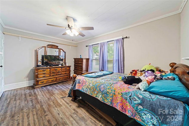 bedroom with hardwood / wood-style floors, ceiling fan, and ornamental molding