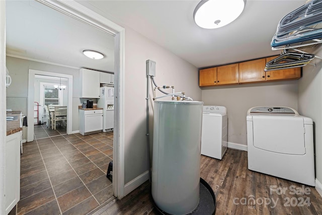 laundry room featuring cabinets, water heater, crown molding, dark hardwood / wood-style flooring, and washing machine and dryer