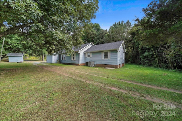 229 Friendship Dr, Ellenboro, NC 28040 - view of front of house with roof with shingles, an outdoor structure, crawl space, a front yard, and a storage shed