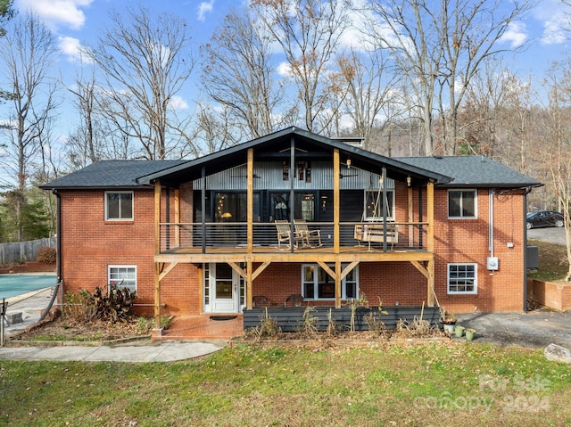 rear view of property with a lawn