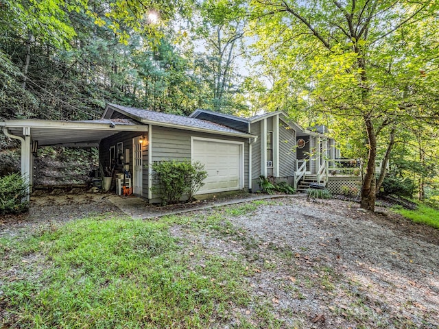 exterior space with a carport and a garage