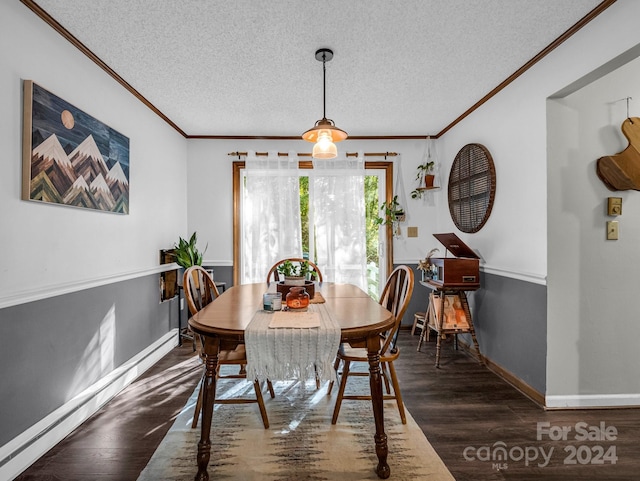 dining area featuring a textured ceiling, ornamental molding, and dark wood-type flooring