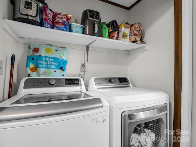 washroom featuring ornamental molding and independent washer and dryer