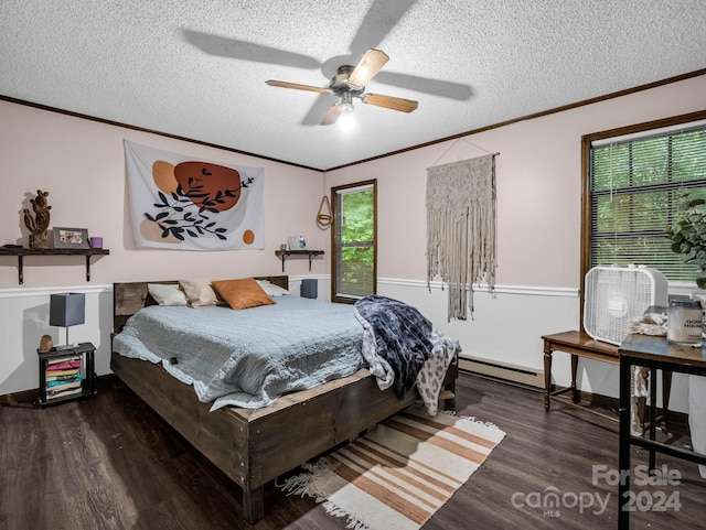 bedroom featuring dark hardwood / wood-style flooring, a textured ceiling, a baseboard radiator, crown molding, and ceiling fan