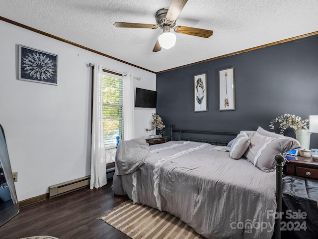 bedroom with a textured ceiling, dark wood-type flooring, a baseboard radiator, crown molding, and ceiling fan