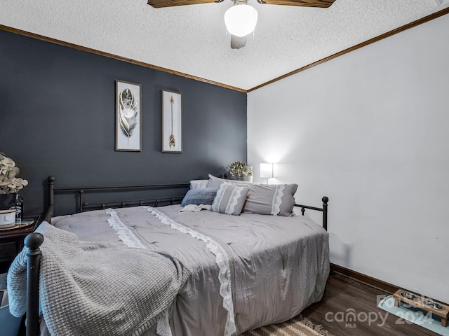 bedroom featuring ornamental molding, a textured ceiling, dark hardwood / wood-style floors, and ceiling fan