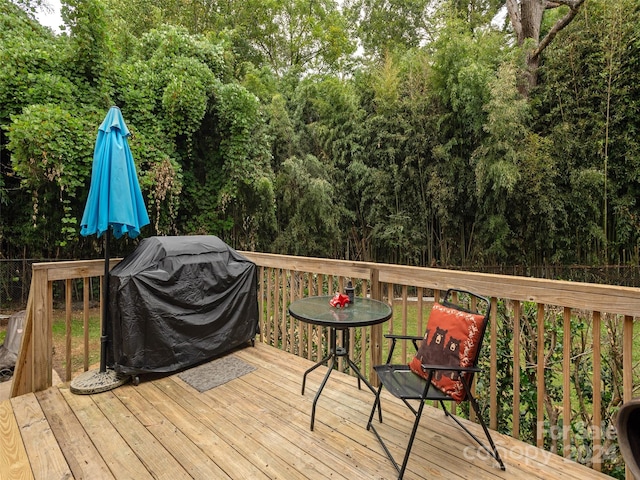 wooden terrace featuring a grill