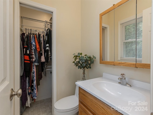 bathroom featuring toilet and vanity