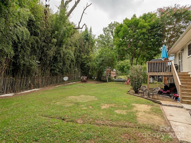 view of yard with a wooden deck