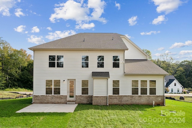 rear view of property featuring a patio and a lawn