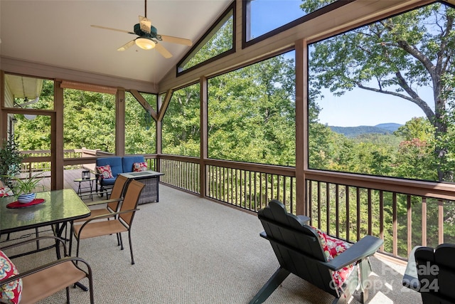 sunroom / solarium featuring ceiling fan and lofted ceiling