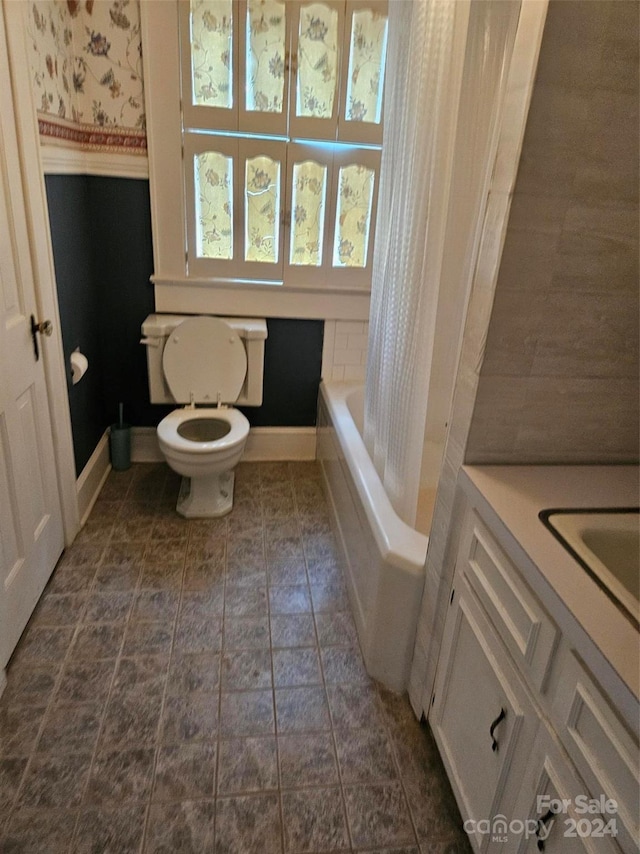 full bathroom with vanity, toilet, and separate shower and tub