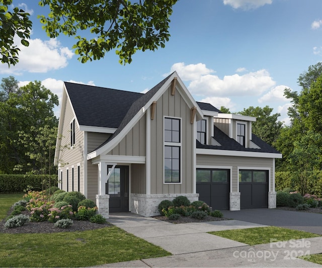 view of front of home featuring a front lawn and a garage