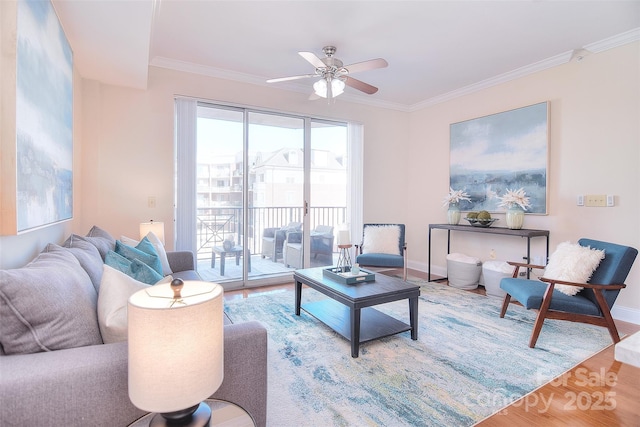 living area featuring ceiling fan, ornamental molding, wood finished floors, and baseboards