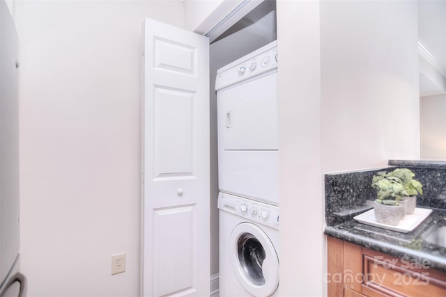 washroom featuring laundry area and stacked washer and clothes dryer