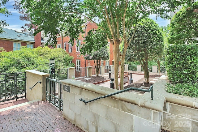 view of property's community with fence and a gate