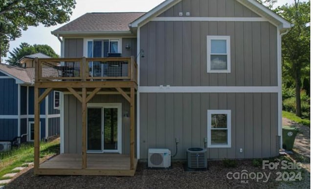 back of property featuring ac unit, cooling unit, a wooden deck, and a balcony