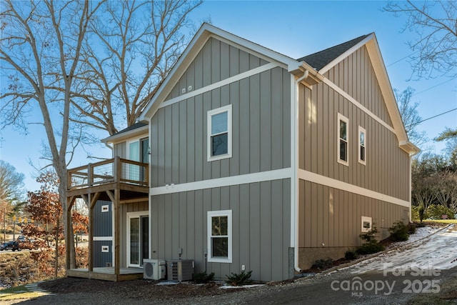 view of side of home featuring a balcony, cooling unit, and ac unit