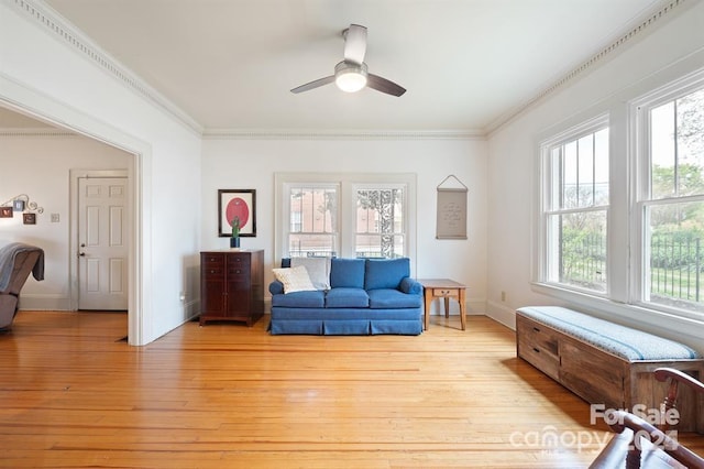 sitting room featuring ceiling fan, a wealth of natural light, crown molding, and light hardwood / wood-style flooring