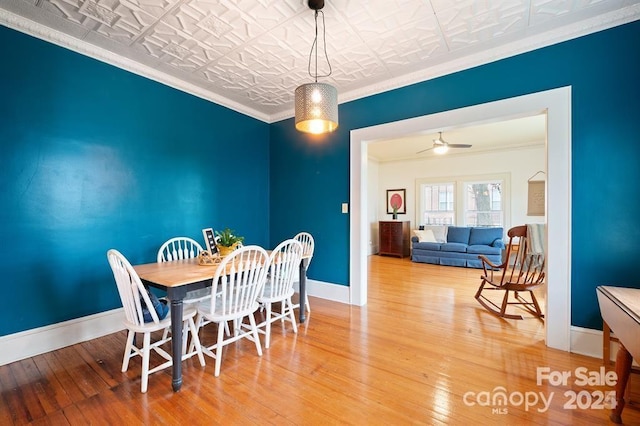 dining space with ornamental molding, ceiling fan, and hardwood / wood-style floors