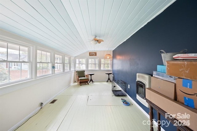 sunroom / solarium featuring lofted ceiling, ceiling fan, wooden ceiling, and heating unit