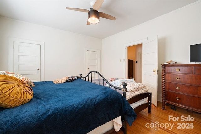 bedroom with hardwood / wood-style flooring and ceiling fan