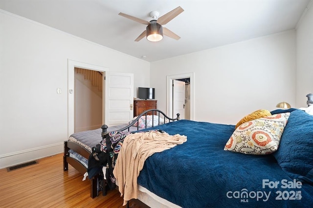 bedroom with hardwood / wood-style floors and ceiling fan