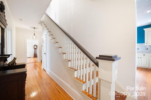 stairs featuring wood-type flooring