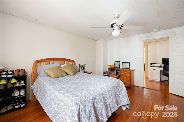 bedroom with ceiling fan and dark hardwood / wood-style floors