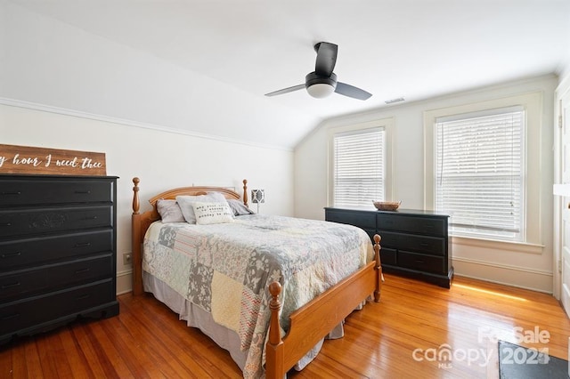 bedroom featuring vaulted ceiling, ceiling fan, and wood-type flooring