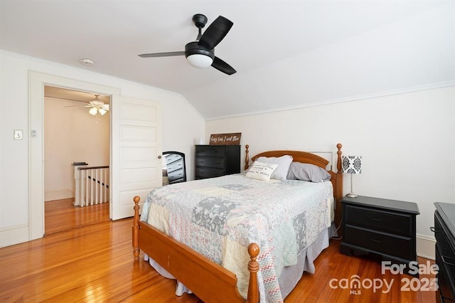 bedroom featuring vaulted ceiling, ceiling fan, and hardwood / wood-style floors