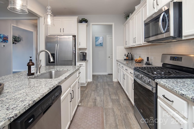 kitchen featuring light hardwood / wood-style flooring, sink, appliances with stainless steel finishes, and white cabinetry