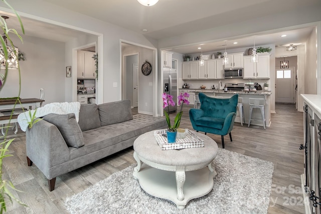 living room with sink and light hardwood / wood-style floors