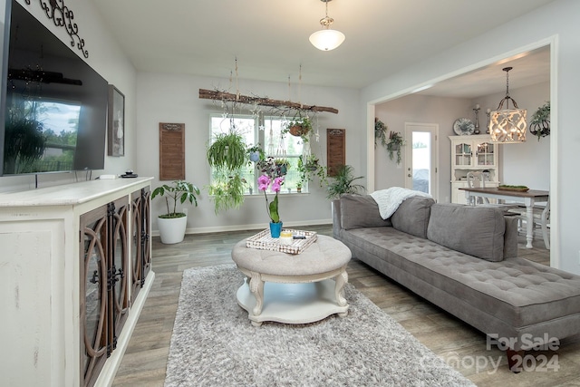 living room featuring a notable chandelier and hardwood / wood-style floors