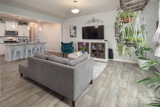 living room with sink and light hardwood / wood-style floors